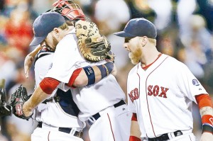 John Lackey, centro, abraza a Jarrod Saltalamacchia, luego de lanzar juego completo para la victoria de Boston. El jardinero Mike Carp, se une al festejo. -  
