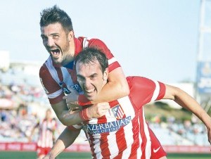 Diego Godin y David Villa celebran el triunfo del Atlético ante el Getafe. (AP ).