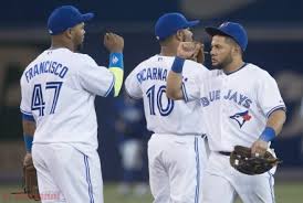 Toronto Blue Jays, from left to right, Juan Francisco, Edwin Encarnacion, and Melky Cabrera celebrate the Blue Jays' 12-6 win over the Philadelphia Phillies in a baseball game in Toronto on Thursday, May 8, 2014. (AP Photo/The Canadian Press, Darren Calabrese).