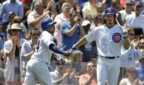Chicago Cubs' Luis Valbuena, left, celebrates with teammate Jeff Samardzija right, after scoring on a Mike Olt sacrifice fly during the fourth inning of an inter league baseball game against the New York Yankees in Chicago, May 21, 2014.