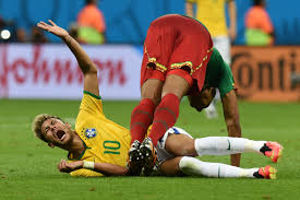 TOPSHOTS Brazil's forward Neymar reacts in pain following a tackle by Cameroon's midfielder Joel Matip during the Group A football match between Cameroon and Brazil at the Mane Garrincha National Stadium in Brasilia during the 2014 FIFA World Cup on June 23, 2014. AFP