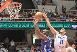 Eloy Vargas, centro de República Dominicana, bloquea un lance de Yoan Haití. de Cuba, en el segundo parcial del encuentro correspondiente a Centrobasket.